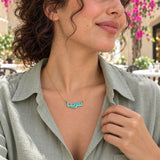 Arabic name enamel necklace worn in a natural lifestyle setting