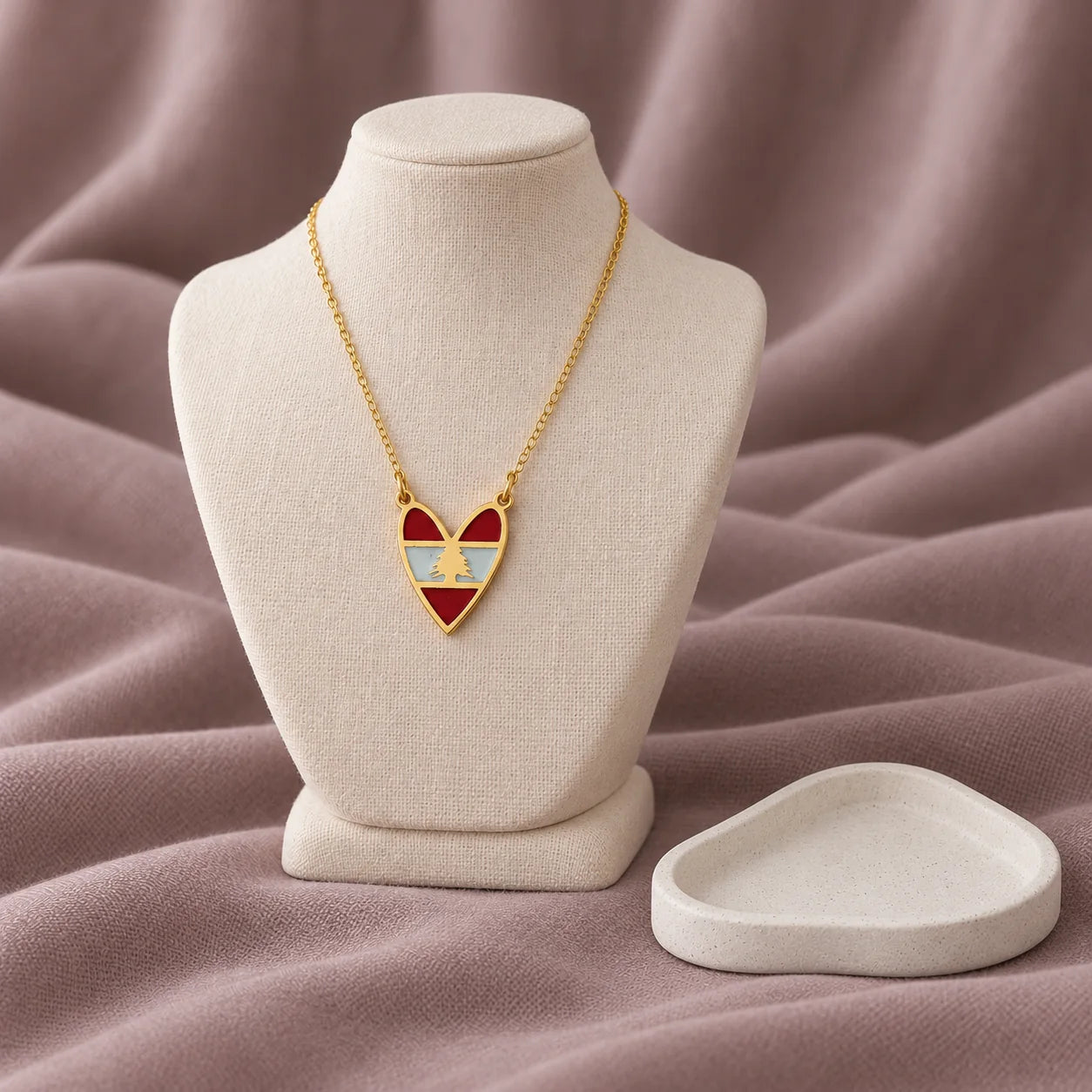 Heart Lebanese Flag Necklace — on ivory display with mauve fabric and white styling props
