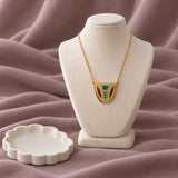 Classic Shaffe Coffee Cup Necklace — on ivory display with mauve fabric and white styling props
