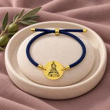 Our Lady of Lebanon Rope Bracelet in Navy Blue on an ivory display and mauve fabric
