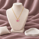 Butterfly Enamel Necklace — on an ivory display with mauve fabric and white styling props