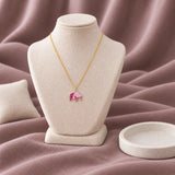 Elephant Enamel Necklace — on an ivory display with mauve fabric and white styling props