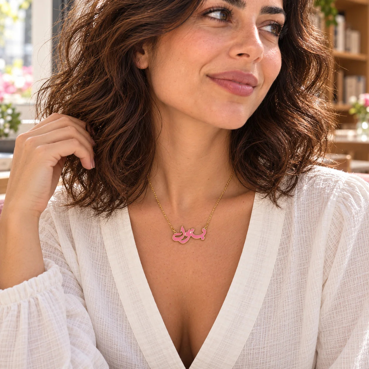 Arabic Name Enamel Necklace — close-up with the same model, outfit and setting