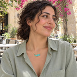 Arabic Block Name Enamel Necklace — worn in a natural lifestyle setting